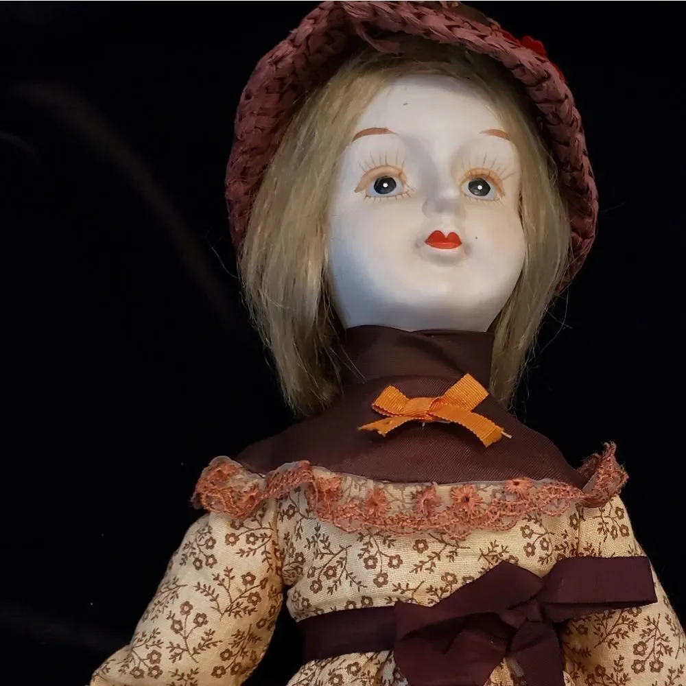 Vintage Porcelain Doll with Brown Dress and Hat